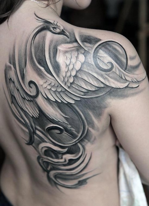 Black and white phoenix tattoo on back of girls shoulder